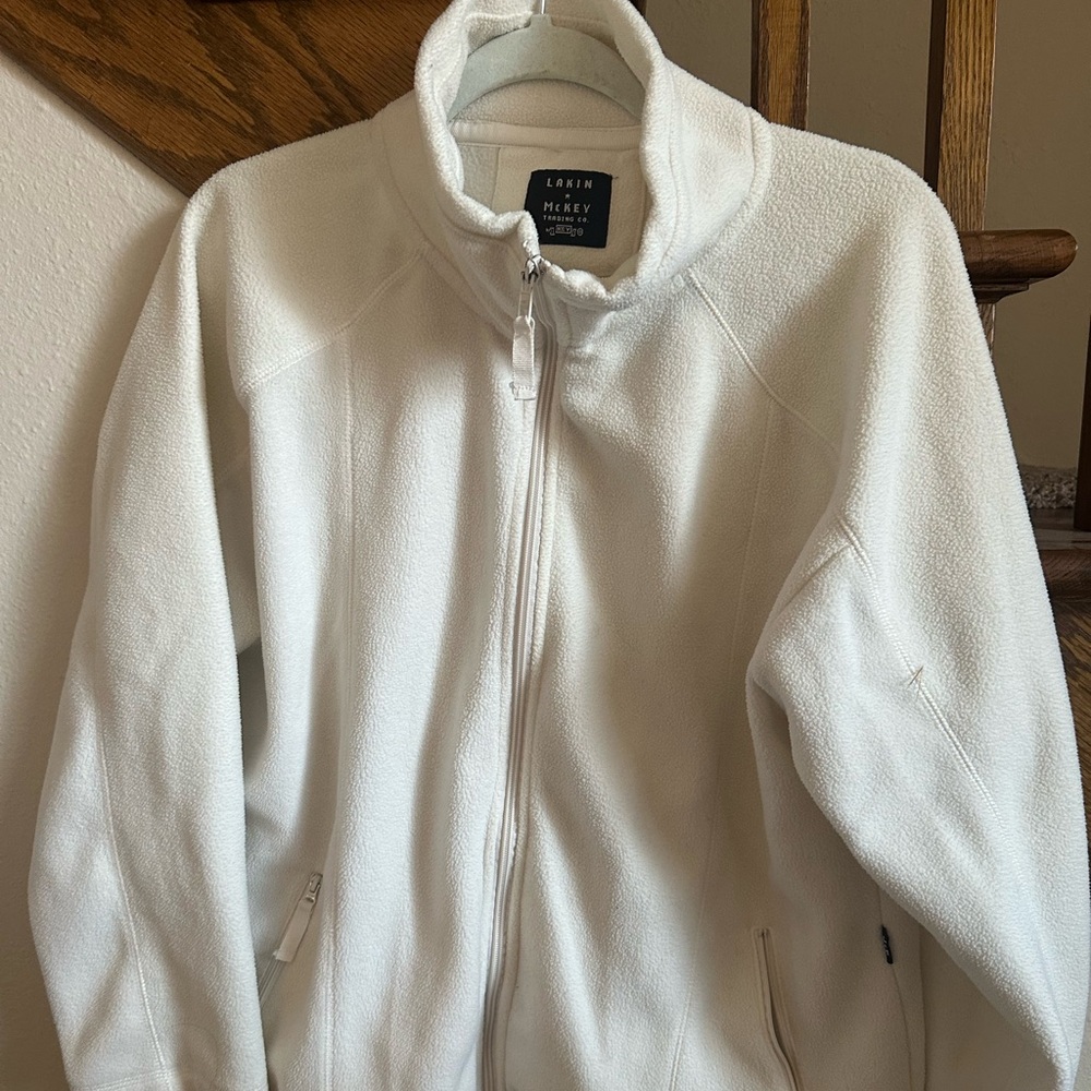 White zip up. Size large but fits oversized as medium or large